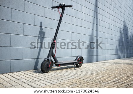 electric scooter near concrete wall  Royalty-Free Stock Photo #1170024346