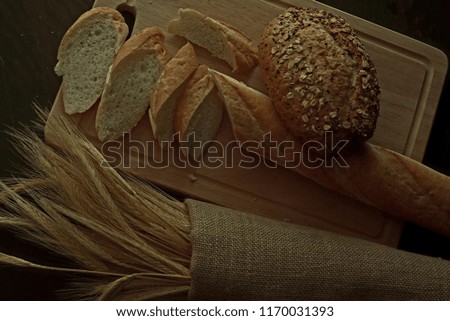 Loaf of bread with wheat in low key or low light condition