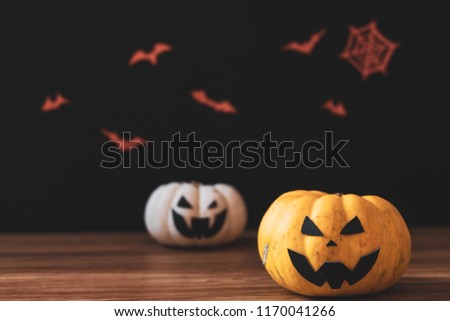 Halloween two pumpkin on wooden table. Black background.