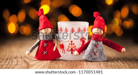 Two little santa decoration on wooden background