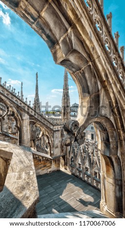 Luxury decoration of the Milan Cathedral roof, Italy. Milan Cathedral or Duomo di Milano is the main tourist attraction of Milan. Amazing ornate exterior of Milan Cathedral on a sunny summer day.