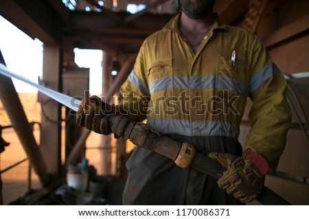 Picture of miner worker hand holding a hose testing water pressure prior to commencing safety hot work at construction site Perth, Australia 
