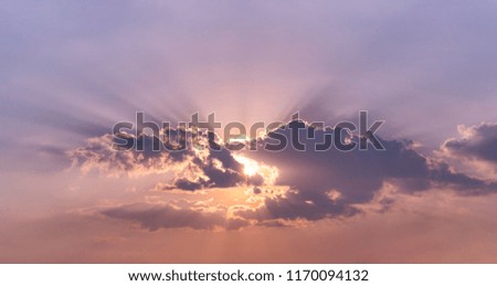 Beautiful sunset with sun is under the cloud background