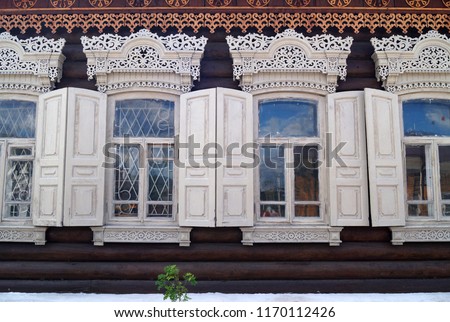 Historical wooden ornaments on siberian old wooden houses, Irkutsk  Royalty-Free Stock Photo #1170112426