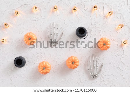 Halloween frame with orange pumpkin, jack-o-lantern garlands on white background. Flat lay, top view