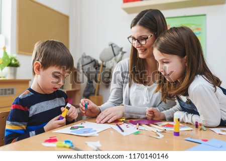 Preschool Teacher with Children at Kindergarten - Creative Art Class Royalty-Free Stock Photo #1170140146