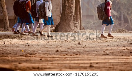 Young girls are walking together around a village road unique photograph