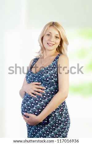 The portrait of the beautiful pregnant woman