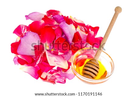 Rose petals and honey on white background. Studio Photo