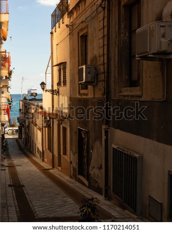 Old and narrow Sicilian street in Giardini Naxos, Taormina. 
