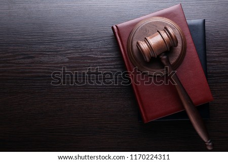 Judge gavel with books on wooden table Royalty-Free Stock Photo #1170224311