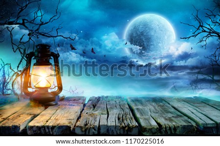 Halloween Lantern On Old Table In Spooky Night
