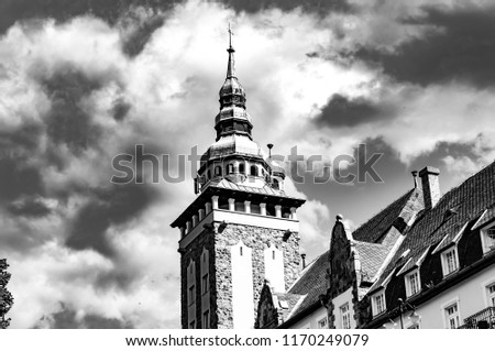 Black and white photo of a historic palace in Lillafured, Hungary, Europe on a sunny day with stormy clouds.