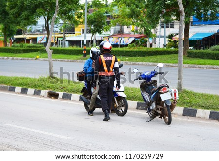 Traffic police stopping and check motorcycle / traffic policeman on the streets and motorcycle rider of Bangkok Thailand 