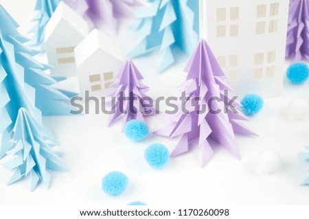 Christmas tree of blue and lilac paper on a white background. Snow white and blue. House of paper craft.