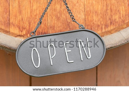 The open sign hanging on the door