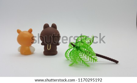 Two bears sitting together isolated in white background