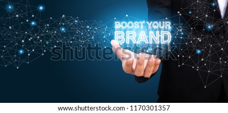 Boost Your Brand in the hand of business. Boost Your Brand concept.