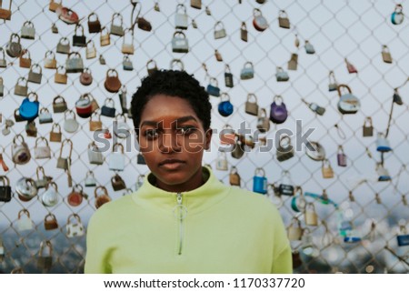 Woman by a fence with padlocks in LA