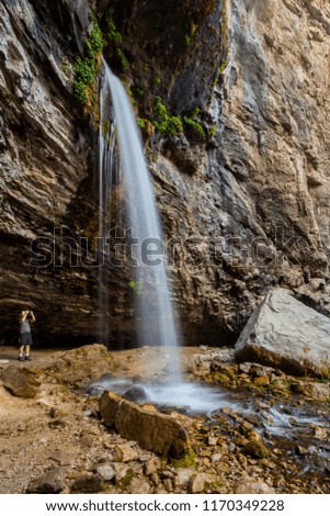 A hiker photographs Spouting Rock Falls in Colorado.