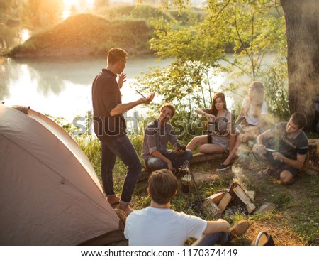 young tourist is pulling the wool over friends' eyes while resting in nature