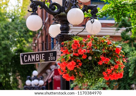 Cambie Street light and sign with hanging flower basket in the heart Gastown, touristy heritage district of Vancouver in British Columbia, Canada