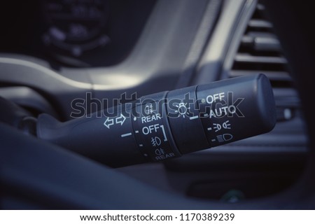 Closeup car light beam head lamp and left or right turn signal controller handle
.