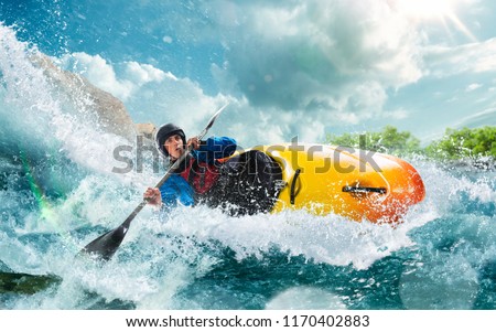 Whitewater kayaking, extreme kayaking. A guy in a kayak sails on a mountain river Royalty-Free Stock Photo #1170402883