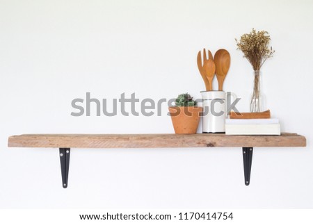 Recipe book and kitchen tools on wooden shelf with copy space