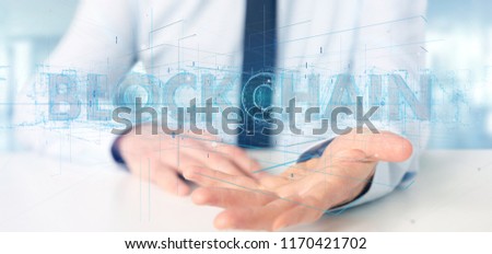 View of a Businessman holding a Blockchain title isolated on a background