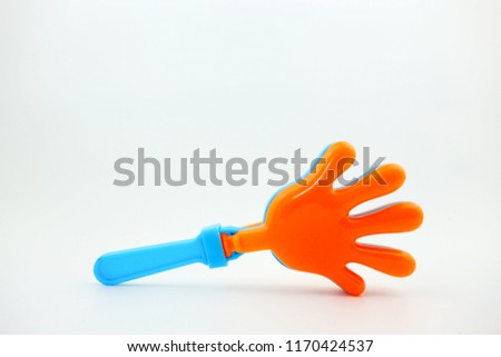 Plastic hand clapper toy on white background