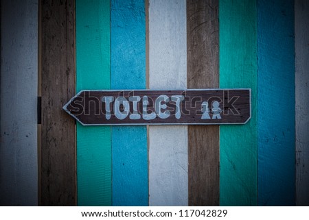 Toilet signs on the old wood wall