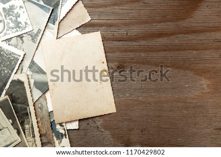 Stack old photos on table. Mock-up blank paper. Postcard rumpled and dirty vintage. Retro card Royalty-Free Stock Photo #1170429802