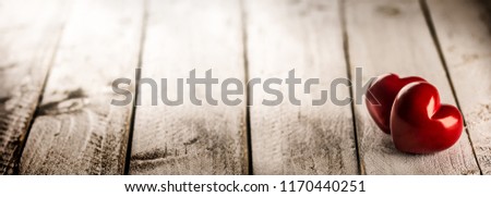 Two red hearts on wooden table. Romantic panoramatic banner for valetines or wedding day. Royalty-Free Stock Photo #1170440251