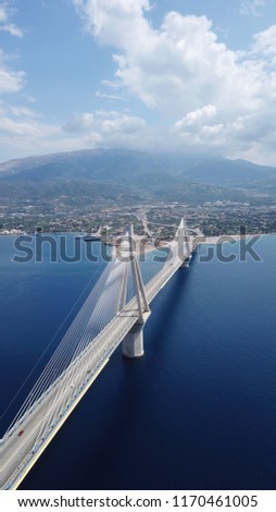 Aerial bird's eye drone photo of state of the art suspension bridge crossing over deep blue sea