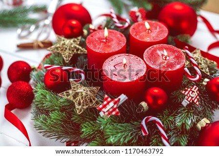 advent wreath with baubles and four red candles