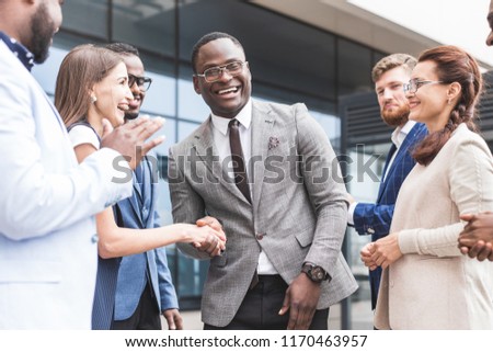 Portrait of an handsome businessman in front of his team. recognition, movement on the career ladder, success in business