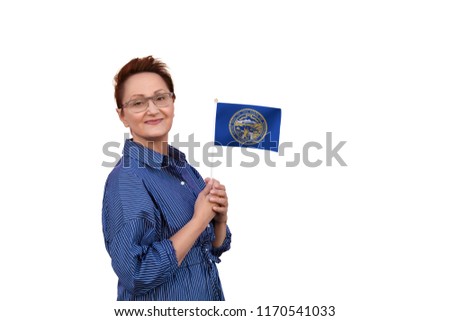 Nebraska flag. Woman holding Nebraska state flag. Nice portrait of middle aged lady 40 50 years old with a state flag isolated on white background.