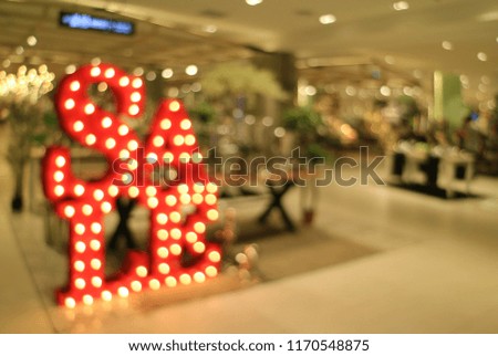Abstract blurred shot of light-up SALE sign in the shopping mall, For Background