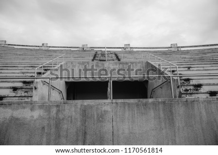 Concrete stairs with iron rails for the grandstand in the stadium. Black and white. Black and white image of an amphitheater in one of the stadiums.