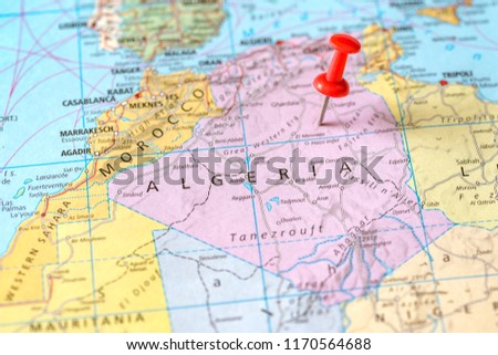 Push pin on the territory of Algeria on the world map