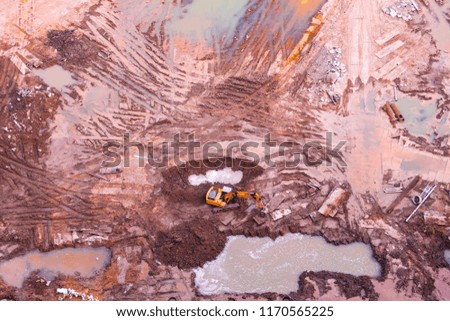 Aerial photograph: a yellow digger is working on the open space of a real estate in the center of the city.