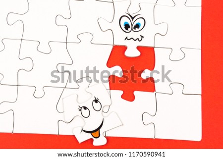 Puzzle pieces with two funny faces and copy space