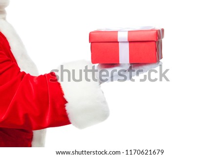 Christmas. Smiling Santa Claus in white gloves is holding a gift red box with a bow. Pointing at the gift. Isolated on white background. Close up
