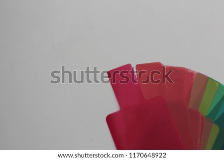 Abstract color gel on white table for background. Color gel for flash indoor photoshoot to give color mood to subjects. 