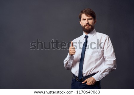 business man in suit on gray background gesturing with hands                              