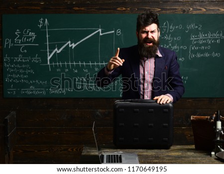 business. Lesson with qualified private tutor. Teacher puts marks. Man looking in laptop display watching training course and listening it. Studying mathematics educational background.