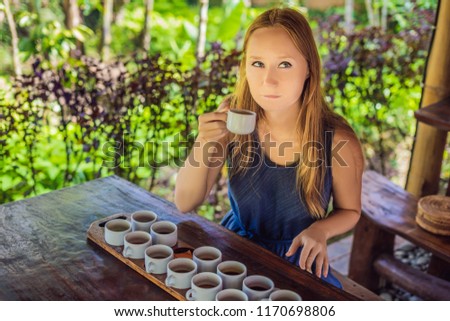 A young woman is tasting different kinds of coffee and tea, including coffee Luwak
