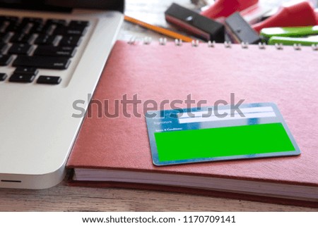 member card on top of table with office stuff and stationery