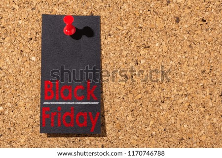 Cork panel, red thumbtack and black paper. Black Friday concept.